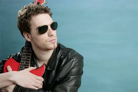 picture of the blue playing a instruments - guitar rock star man sunglasses and leather perfect jacket over blue Stock Photo - Budget Royalty-Free & Subscription, Code: 400-05241027