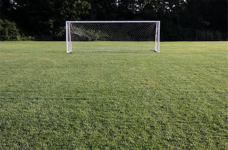 penalty - A soccer net with shot in bright sunlight with trees in the background. Stock Photo - Budget Royalty-Free & Subscription, Code: 400-05241542