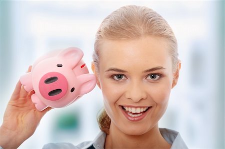 rich women with money laughing - Businesswoman holding piggy bank. Isolated on white background Stock Photo - Budget Royalty-Free & Subscription, Code: 400-05243393