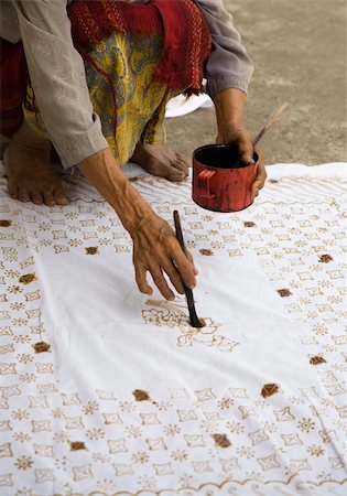 Batik maker is applying melted wax following a pattern Stock Photo - Budget Royalty-Free & Subscription, Code: 400-05255776