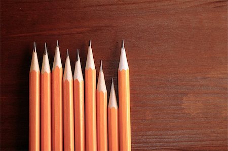 Few pencils standing in a row on dark wooden background with copy space Stock Photo - Budget Royalty-Free & Subscription, Code: 400-05259086