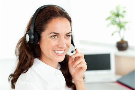 simsearch:400-05287143,k - Smiling woman with headset working in a call center against a white background Stock Photo - Budget Royalty-Free & Subscription, Code: 400-05259173