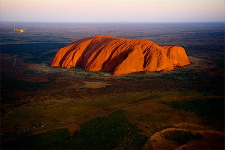 simsearch:400-03947083,k - Uluru./ Orange Uluru in bright beams of the sunset sun. Aerial photography. Stock Photo - Budget Royalty-Free & Subscription, Code: 400-05251341