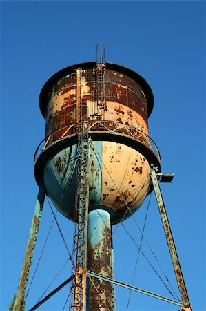 A Old rusty watertower against blue sky Stock Photo - Budget Royalty-Free & Subscription, Code: 400-05253095