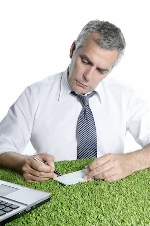 senior businessman signing bank check over green grass desk sport ecology Stock Photo - Budget Royalty-Free & Subscription, Code: 400-05253296