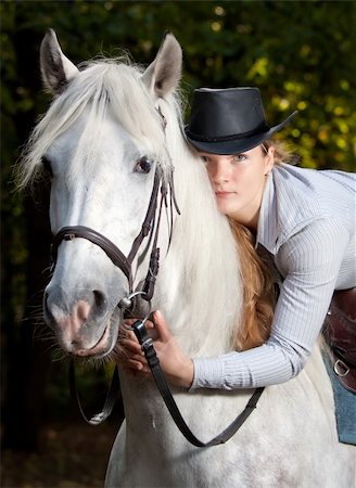Young Lady in hat hugging her horse Stock Photo - Budget Royalty-Free & Subscription, Code: 400-05264938