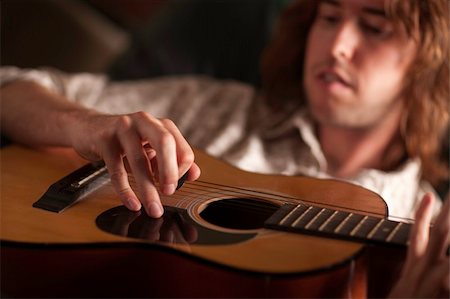 simsearch:400-04863651,k - Young Musician Plays His Acoustic Guitar under Dramatic Lighting. Stock Photo - Budget Royalty-Free & Subscription, Code: 400-05262057