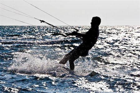 silhouette of a kitesurfer jumping in the waves Stock Photo - Budget Royalty-Free & Subscription, Code: 400-05275297