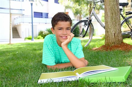simsearch:400-04704759,k - boy teenager homework studying laying green grass garden bicycle background Stock Photo - Budget Royalty-Free & Subscription, Code: 400-05276443