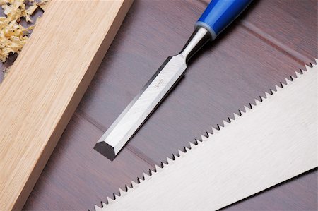 Wooden brick, chisel and handsaw on the floor Stock Photo - Budget Royalty-Free & Subscription, Code: 400-05277507