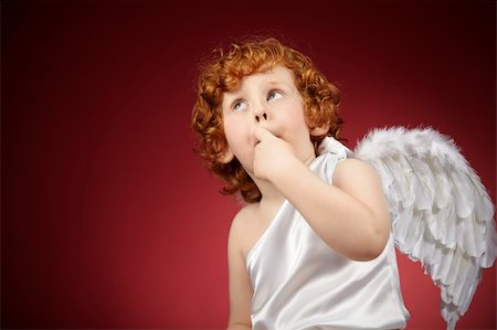 Portrait of the little boy with wings behind the back on a red background Stock Photo - Budget Royalty-Free & Subscription, Code: 400-05279764