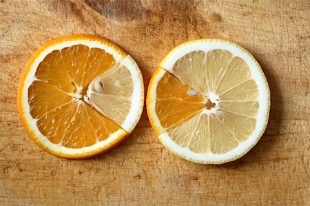 Mixed slices of lemon and orange lying on wooden background Stock Photo - Budget Royalty-Free & Subscription, Code: 400-05285096