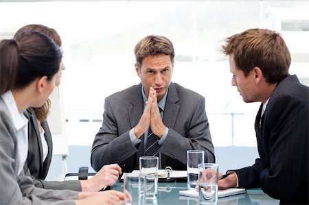 Serious manager talking to his team during a meeting in the office Stock Photo - Budget Royalty-Free & Subscription, Code: 400-05297953