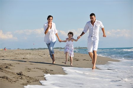 simsearch:400-05309800,k - happy young family in white clothing have fun at vacations on beautiful beach Stock Photo - Budget Royalty-Free & Subscription, Code: 400-05291156