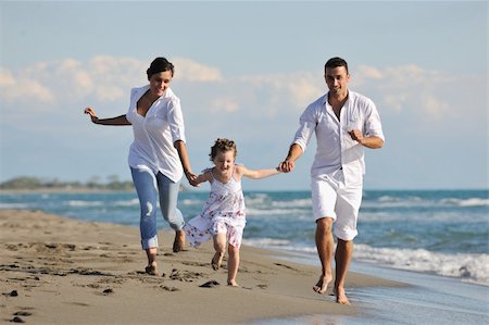 simsearch:400-05309800,k - happy young family in white clothing have fun at vacations on beautiful beach Stock Photo - Budget Royalty-Free & Subscription, Code: 400-05291157