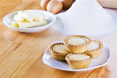 simsearch:400-04370315,k - Freshly made apple pies on the table with flour eggs and butter Stock Photo - Budget Royalty-Free & Subscription, Code: 400-05291250