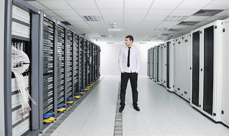 young handsome business man  engeneer in datacenter server room Stock Photo - Budget Royalty-Free & Subscription, Code: 400-05291401