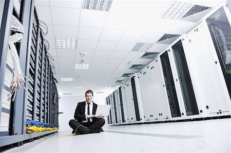 simsearch:400-04239432,k - young engeneer business man with thin modern aluminium laptop in network server room Stock Photo - Budget Royalty-Free & Subscription, Code: 400-05291415