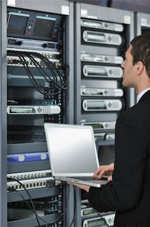 simsearch:400-05291415,k - young engeneer business man with thin modern aluminium laptop in network server room Stock Photo - Budget Royalty-Free & Subscription, Code: 400-05291411