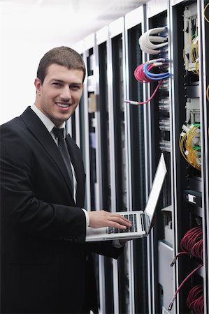 simsearch:400-05291415,k - young engeneer business man with thin modern aluminium laptop in network server room Stock Photo - Budget Royalty-Free & Subscription, Code: 400-05291412