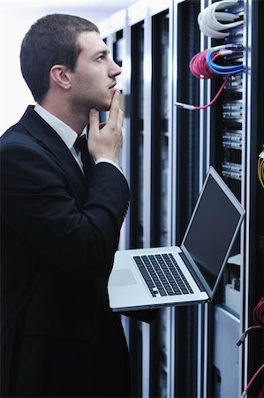 simsearch:400-05291415,k - young engeneer business man with thin modern aluminium laptop in network server room Stock Photo - Budget Royalty-Free & Subscription, Code: 400-05291413