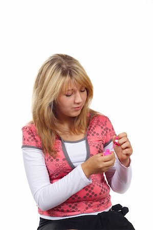 Young woman painting her nails isolated on white background Stock Photo - Budget Royalty-Free & Subscription, Code: 400-05304847