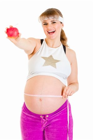 simsearch:400-04798379,k - Smiling beautiful pregnant woman measuring her belly and holding apple isolated on white Stock Photo - Budget Royalty-Free & Subscription, Code: 400-05307619