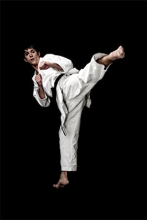 simsearch:400-05908874,k - Karate male fighter young high contrast on black background Stock Photo - Budget Royalty-Free & Subscription, Code: 400-05308172
