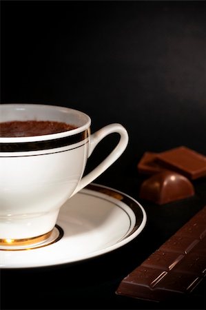 simsearch:700-03698239,k - A white cup filled with hot luxury chocolate drink and chocolate bars on black background Stock Photo - Budget Royalty-Free & Subscription, Code: 400-05308592