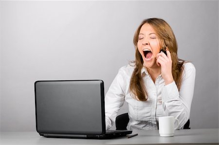 business woman is sitting in the office with laptop and yawning Stock Photo - Budget Royalty-Free & Subscription, Code: 400-05309960