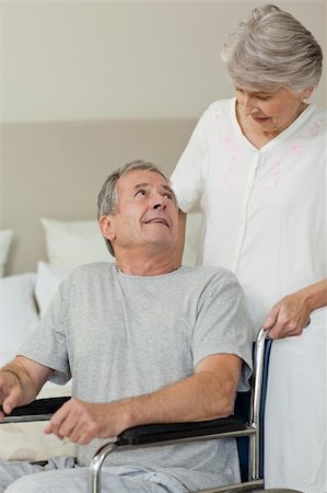 Retired man in his wheelchair with his wife Stock Photo - Budget Royalty-Free & Subscription, Code: 400-05314493