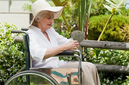 Mature woman in her wheelchair in the garden Stock Photo - Budget Royalty-Free & Subscription, Code: 400-05314659