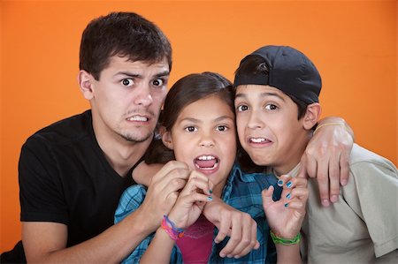 Elder brother with two younger siblings wearing a scared look Stock Photo - Budget Royalty-Free & Subscription, Code: 400-05315156