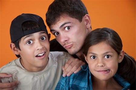 Elder brother with two younger siblings making faces Stock Photo - Budget Royalty-Free & Subscription, Code: 400-05315151