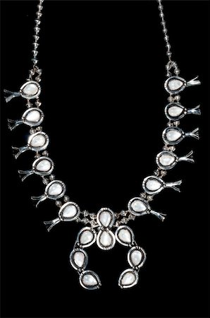 Silver squash blossom navajo necklace with opal gems on black background Stock Photo - Budget Royalty-Free & Subscription, Code: 400-05318084