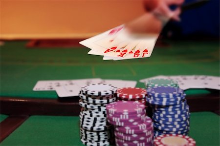 queen of hearts playing card - royal flush has poker player showing winning hand of cards with the chips in the foreground Stock Photo - Budget Royalty-Free & Subscription, Code: 400-05327426