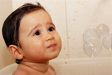 simsearch:400-04071604,k - Baby watching the water and bubbles while taking a bath. Stock Photo - Budget Royalty-Free & Subscription, Code: 400-05323159