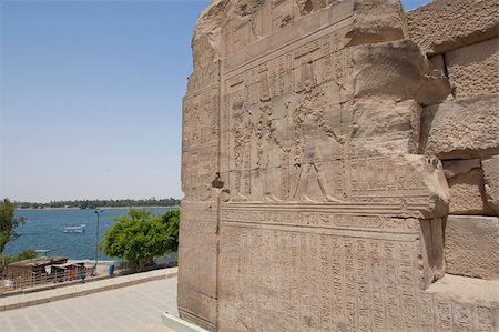 Egyptian hieroglyphic carvings on an outside wall at the Temple of Kom Ombo with view of River Nile Stock Photo - Budget Royalty-Free & Subscription, Code: 400-05334220