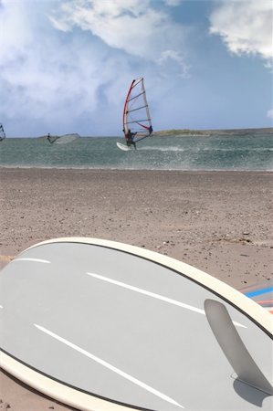 simsearch:400-03992760,k - surfboard lying on the beach as surfers windsurf in the maharees in county kerry ireland during a storm Stock Photo - Budget Royalty-Free & Subscription, Code: 400-05334522