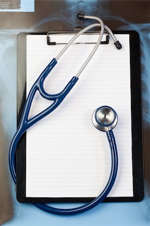 Note pad and blue stethoscope on a blue and dark background Stock Photo - Budget Royalty-Free & Subscription, Code: 400-05335124