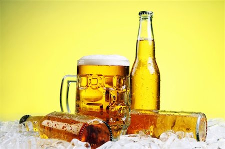 simsearch:400-04083275,k - Bottles and Glass of beer with foam over yellow background Stock Photo - Budget Royalty-Free & Subscription, Code: 400-05335557