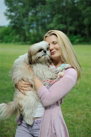 simsearch:400-04875272,k - Pretty casual woman with cute little shih tzu dog outdoors in a park Stock Photo - Budget Royalty-Free & Subscription, Code: 400-05337175