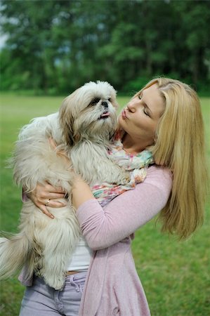 simsearch:400-04875272,k - Pretty casual woman with cute little shih tzu dog outdoors in a park Stock Photo - Budget Royalty-Free & Subscription, Code: 400-05337176