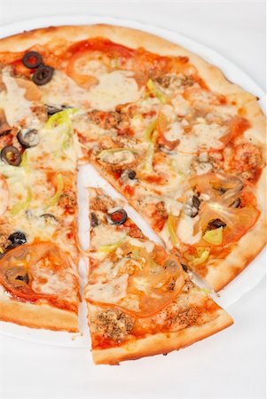 simsearch:400-04479187,k - seafood pizza closeup with salmon, shrimps, tomato, pepper, olive and mozzarella cheese on a white background Stock Photo - Budget Royalty-Free & Subscription, Code: 400-05332635