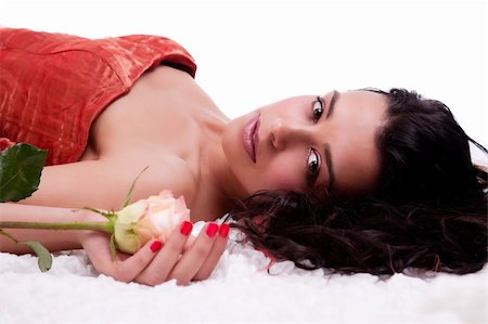 simsearch:400-04653285,k - Beautiful woman lying, with a rose, on white, studio shot Photographie de stock - Aubaine LD & Abonnement, Code: 400-05333377