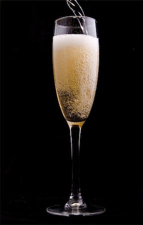 simsearch:400-04558755,k - Wine being poured into a glass on black background Stock Photo - Budget Royalty-Free & Subscription, Code: 400-05344497
