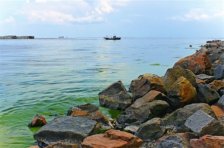 Bay with rocky shore near Ochakiv, Ukraine. Large boulders piled on the heap Stock Photo - Budget Royalty-Free & Subscription, Code: 400-05345837