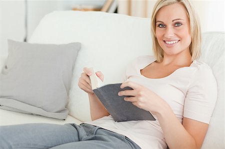 simsearch:400-04418460,k - Smiling woman holding a book while looking at the camera Stock Photo - Budget Royalty-Free & Subscription, Code: 400-05345855