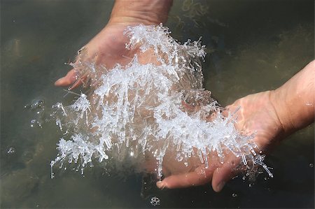 Hand holding salt crystals from salt lake above the water surface Stock Photo - Budget Royalty-Free & Subscription, Code: 400-05341491