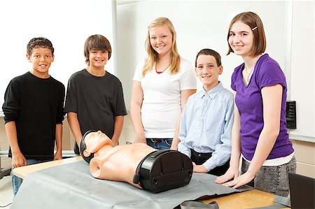 simsearch:400-07411030,k - Group of teenagers with a CPR training dummy, about to learn cardiopulmonary resuscitation. Stock Photo - Budget Royalty-Free & Subscription, Code: 400-05341683